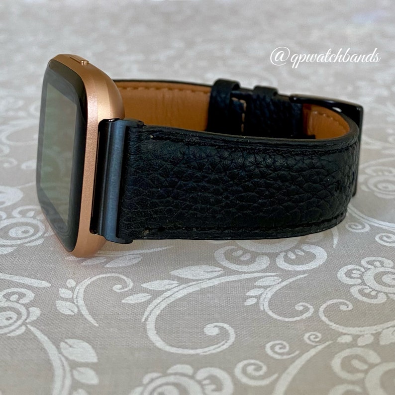 May include: A rose gold smartwatch with a black leather band. The band has a textured surface and a brown leather lining. The watch face is black and rectangular. The text "@gpwatchbands" is visible in the upper right corner of the image.