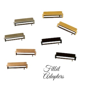 May include: Eight different colored metal watch band adapters for Fitbit watches. The adapters are in gold, silver, rose gold, and black.