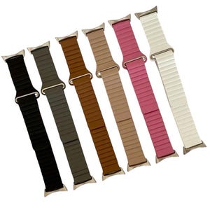 May include: Seven different colored watch bands with a silver buckle. The bands are made of a textured material and are available in black, gray, brown, beige, pink, and white.