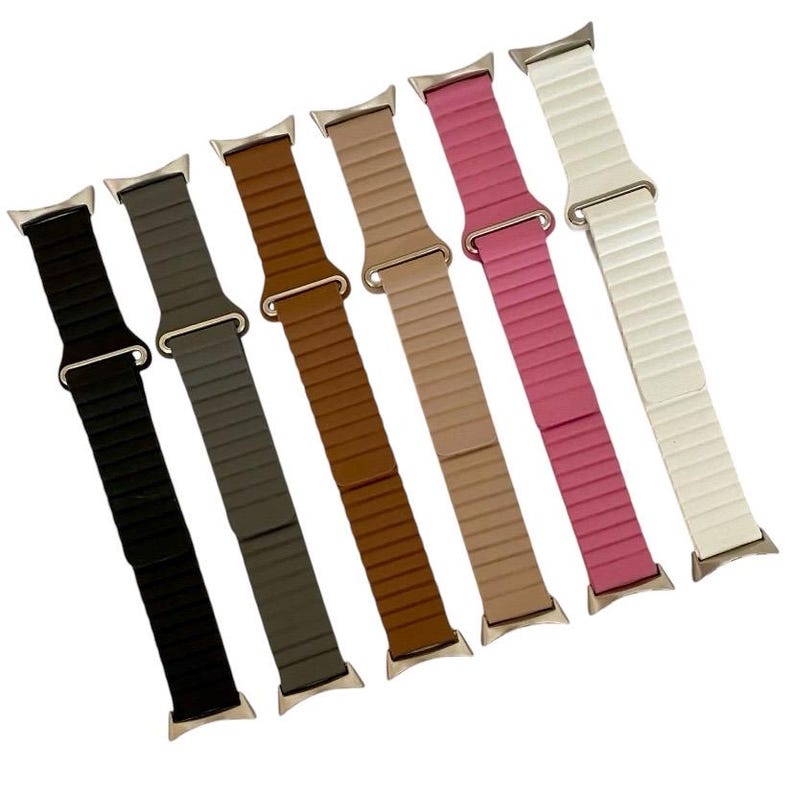 May include: Seven different colored watch bands with a silver buckle. The bands are made of a textured material and are available in black, gray, brown, beige, pink, and white.