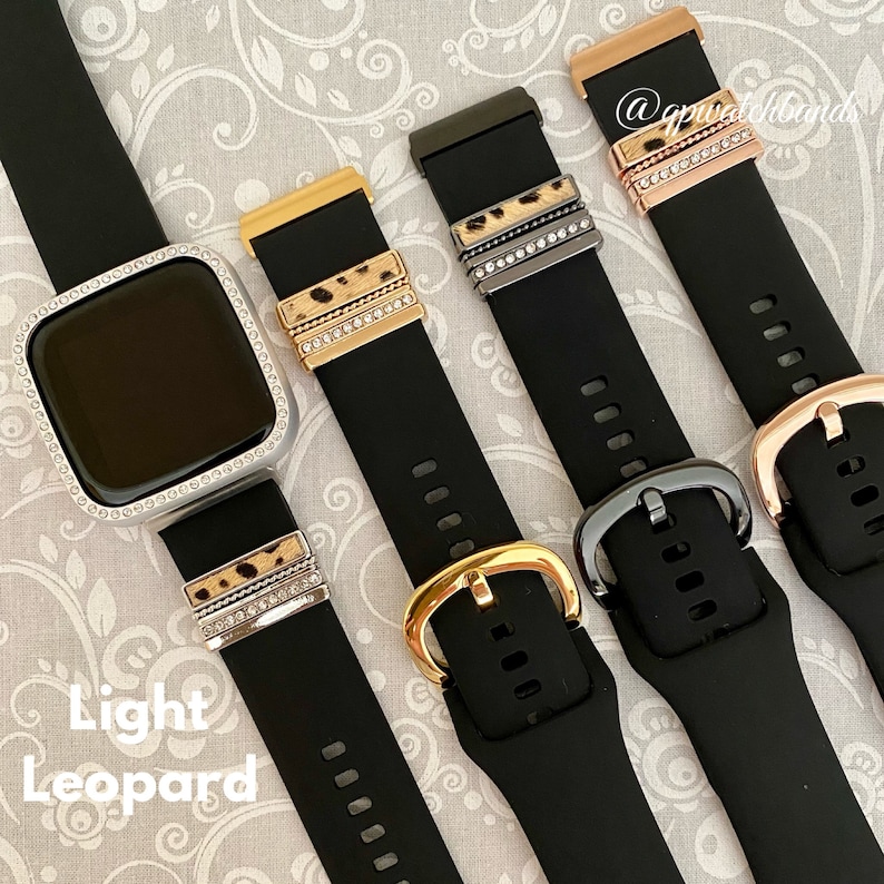 May include: Four black watch bands with different colored buckles and decorative bands. The bands have a leopard print design and are adorned with rhinestones. The text "Light Leopard" is visible in the bottom left corner of the image.