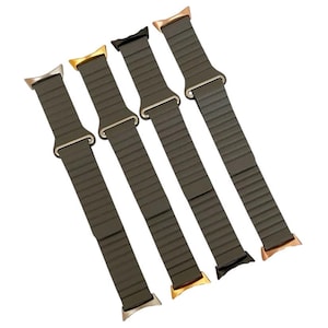May include: Four different colored watch bands with a dark green silicone strap and a metal buckle. The bands are arranged in a row, with the buckles facing the viewer.