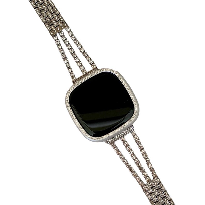 May include: A silver watch with a black face and a diamond-encrusted band.