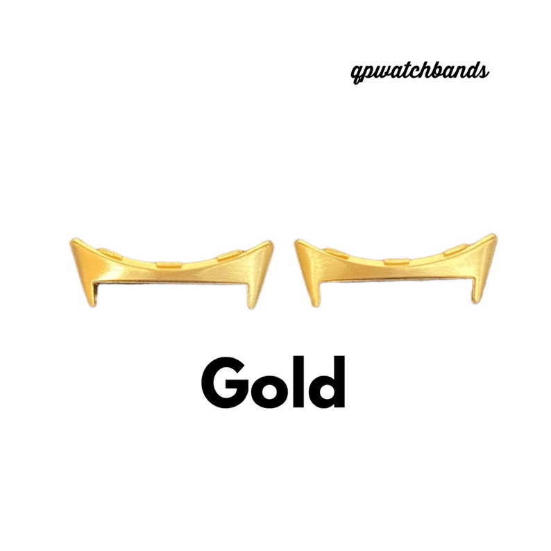 May include: Two gold-coloured metal watch band spring bars. The spring bars are curved and have a slight bend at each end.