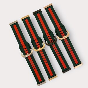 May include: Four different colored watch bands with a green and red striped pattern. The bands have gold, silver, and black buckles.