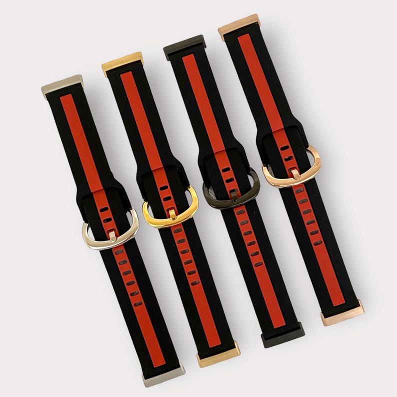 May include: Four black watch bands with red stripes and different colored metal buckles. The bands have a textured surface and are designed for smartwatches.