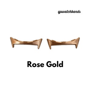 May include: Two rose gold watch band spring bars. The spring bars are curved and have a polished finish. gpwatchbands.