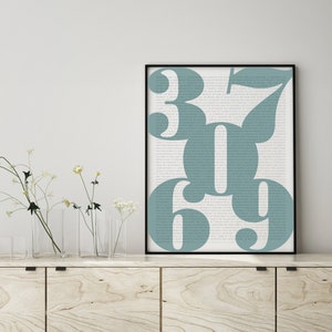 May include: A framed print with a white background and large teal numbers 3069. The numbers are made up of small text.