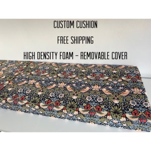 May include: A custom cushion with a removable cover featuring a floral pattern with birds and strawberries. The fabric is dark blue with green, pink, and red accents. The text "CUSTOM CUSHION", "FREE SHIPPING", and "HIGH DENSITY FOAM - REMOVABLE COVER" is printed on a white background above the cushion.