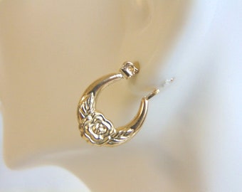 May include: Gold hoop earrings with a rose design. The earrings are simple and elegant.