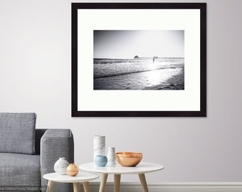 Fine art black and white photographic print of boy running in the surf, in Long Beach, CA. Print or Framed Print Available