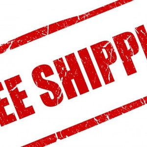 May include: A red rectangular stamp with the words "FREE SHIPPING" in bold, distressed font. The stamp is slightly angled, with a white background. The text is in a bold, sans-serif font.