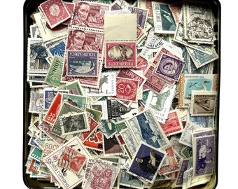 A huge set of over 2,000 vintage stamps in a biscuit tin.