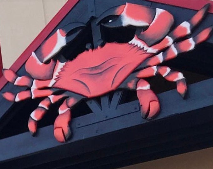 Red wooden crab Seafood Restaurant outdoor decor. Entryway large crab wood. Juicy seafood crab entry sign