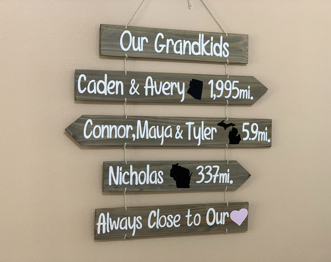 Grandkids sign with names, state maps and mileages. Grand kids directional sign wood on rope