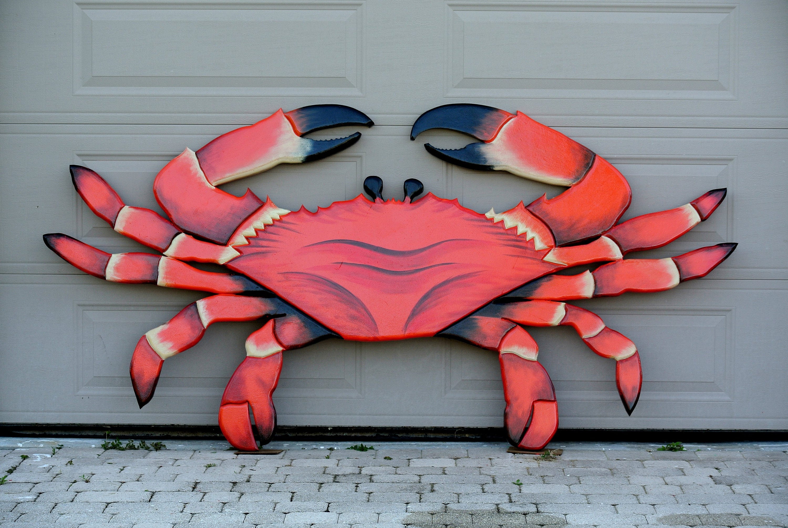 Red wooden crab Seafood Restaurant outdoor decor. Entryway large crab