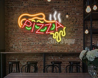 May include: A neon sign with the word "PIZZA" in red, yellow, and green letters. The sign is shaped like a pizza slice with a yellow crust and red sauce. The sign is hanging on a brick wall above a table with black chairs.