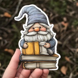 May include: A blue gnome with a white beard sits on a stack of books. The gnome is wearing a blue hat and holding a yellow book. The books are stacked on top of each other and have brown covers.