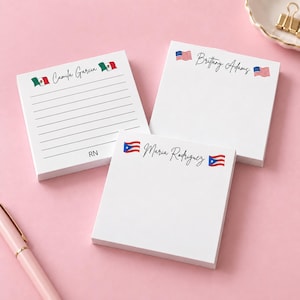 May include: Three square white sticky note pads with custom printed names and flags. One pad features the name Camila Garcia with Mexican flags and the letters RN. Another shows Brittany Adams with US flags. The third displays Maria Rodriguez with Puerto Rican flags.