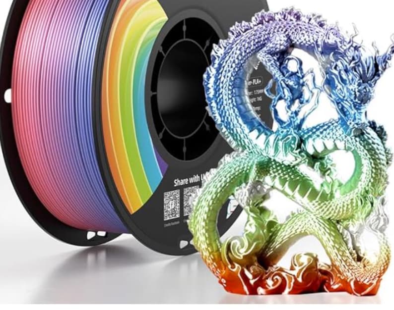 May include: A rainbow-colored 3D printing filament spool next to a multi-colored dragon figurine. The filament transitions through pink, blue, yellow, and green. The dragon sculpture has a detailed design and a gradient of colors.