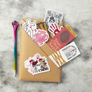 May include: A brown paper envelope filled with true crime themed stickers and bookmarks. The stickers feature a fingerprint, a bloody handprint, a person with blood splatters, and a stack of books. The bookmarks feature a fingerprint, a stack of books with a bloody knife, and the text "True Crime Junkie".