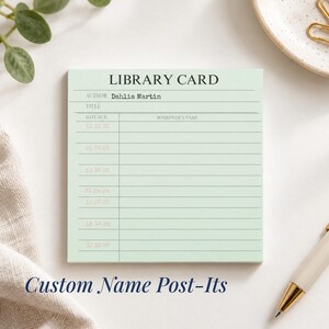May include: A square light green sticky note designed as a vintage library card. The text reads LIBRARY CARD, AUTHOR Dahlia Martin, TITLE, DATE DUE, and BORROWER'S NAME. It features horizontal lines for writing and a vertical column for dates.