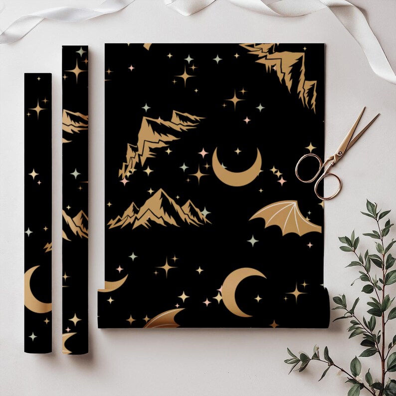 ACOTAR Themed Gift Wrap Collection Rhysand Night Court Design Black Gold Pattern Wing Motif Details Star Mountain Artwork Elegant Present Packaging Special Occasion Paper Beautiful Artistic Creation Multiple Size Options Fantasy Wrapping
