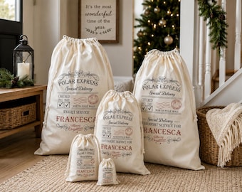 May include: A set of five off-white canvas drawstring bags in varying sizes, each printed with black and red text reading Polar Express Special Delivery, North Pole Mail, and the name Francesca, featuring decorative flourishes and postal stamps.