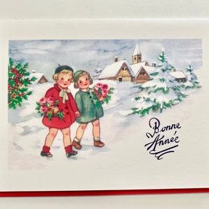 May include: A vintage greeting card with a red border. The card features a winter scene with two children in coats carrying flowers, walking in the snow. The words "Bonne Année" are written in cursive.