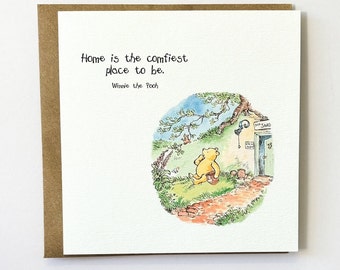 May include: A Winnie the Pooh illustration with a quote that reads "Home is the comfiest place to be." Winnie the Pooh is standing outside his house with a pot in his hand. The house has a sign that reads "Pooh's  Shed".