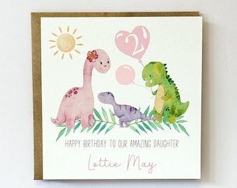 May include: A pink, green, and purple dinosaur birthday card with a sun, a heart-shaped balloon with the number 2, and the text "Happy Birthday to our amazing daughter Lottie May".