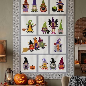 May include: A rectangular wall hanging quilt featuring a series of appliqued gnome characters dressed in witch and wizard costumes. The quilt has a grey border with a black spiderweb pattern and displays various gnomes with hats, brooms, and pumpkins.