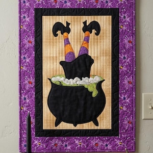 May include: A rectangular fabric wall hanging featuring a black cauldron with green bubbling liquid and two legs in orange and purple striped stockings sticking out. The border is purple with a spiderweb pattern and a black metal hanger.