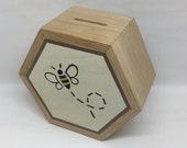A Beautifully Hand Made Solid Oak Hexagonal Money Box Hand Decorated with a Flying Honey Bee Marquetry Design