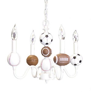 May include: White chandelier with five light bulbs and six sports ball-shaped shades. The shades are a baseball, football, soccer ball, and three basketballs.