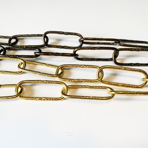 May include: Two chains, one gold and one bronze, with textured oval links.