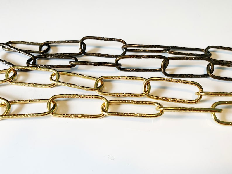 May include: Two chains, one gold and one bronze, with textured oval links.