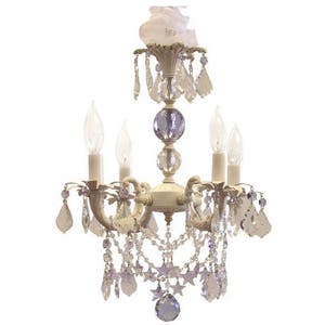 May include: A white chandelier with crystal drops and star accents. The chandelier has five lights and a white fabric shade.