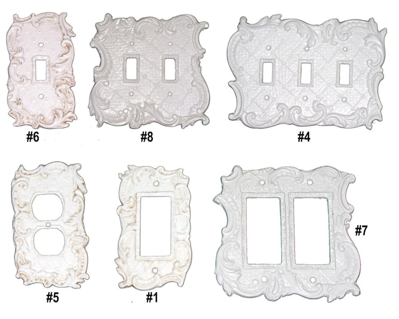 May include: Six different white decorative light switch and outlet covers with ornate designs. The covers are numbered 1 through 8.