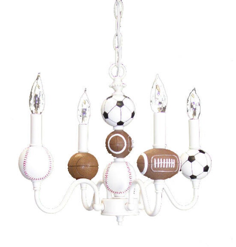 May include: White chandelier with five light bulbs and six sports ball-shaped shades. The shades are a baseball, football, soccer ball, and three basketballs.