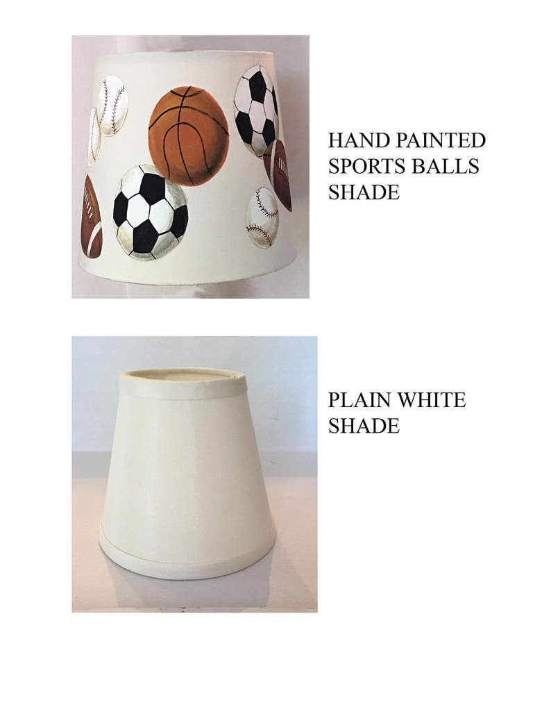 May include: Two lampshades, one plain white and the other with hand-painted sports balls. The sports balls include a basketball, baseball, soccer ball, and football.
