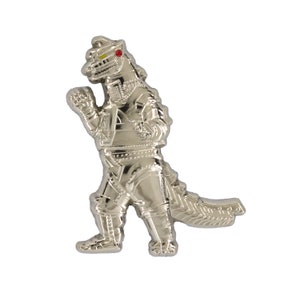 May include: A silver-colored metal pin of a robot dinosaur in a fighting pose. The robot dinosaur has red and yellow eyes.