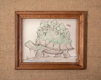 May include: A framed artwork depicts a turtle with a forest on its back. The drawing is in shades of green, gray, and brown, with a light background. The wooden frame adds a rustic touch to the artwork, which is displayed against a textured, tan background.