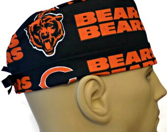 May include: Black and orange scrub hat with the Chicago Bears logo and the words "Bears" repeated on the fabric.