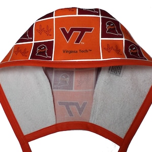 May include: Orange and maroon hooded towel with a checkered pattern featuring the Virginia Tech logo, a mascot, and the words "Virginia Tech".