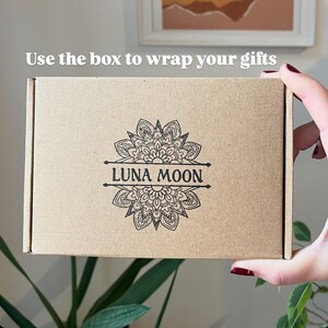 May include: A brown cardboard box with the text "Use the box to wrap your gifts" printed on the top. The box has a black and white mandala design with the text "LUNA MOON" printed in the center.