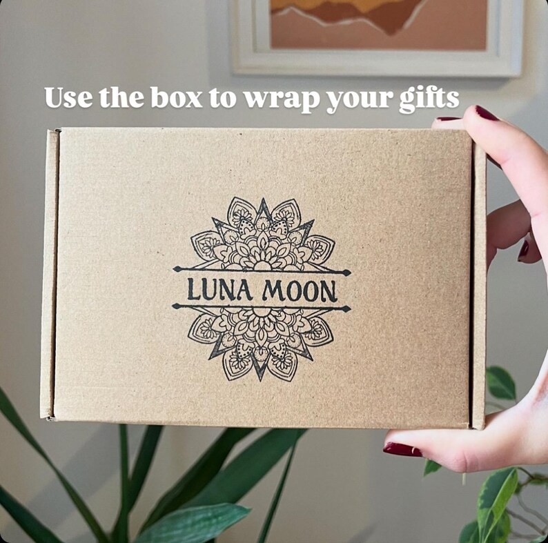 May include: A brown cardboard box with the text "Use the box to wrap your gifts" printed on the top. The box has a black and white mandala design with the text "LUNA MOON" printed in the center.