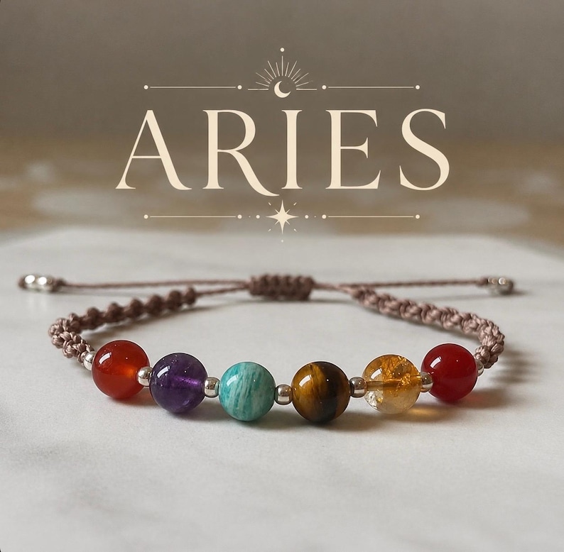 May include: A bracelet for Aries, featuring a series of colourful gemstone beads, including red, purple, turquoise, brown, and yellow. The bracelet is strung on a brown cord with adjustable ends. The word "ARIES" is displayed above.