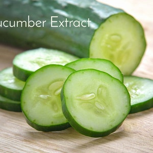 May include: Cucumber Extract. A whole cucumber and several slices of cucumber on a wooden surface.