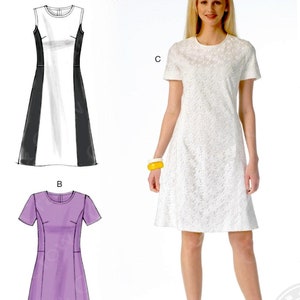 May include: McCall's M7169 sewing pattern featuring three dress designs. The pattern includes a white lace dress, a black and white color-blocked dress, and a purple dress. The size range is B5 (8-10-12-14-16).
